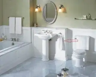 A picture of a bathroom with a red arrow pointing to a towel